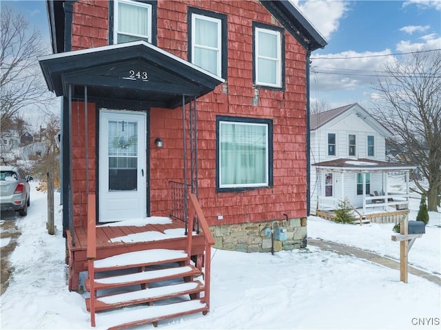 view of snow covered property entrance