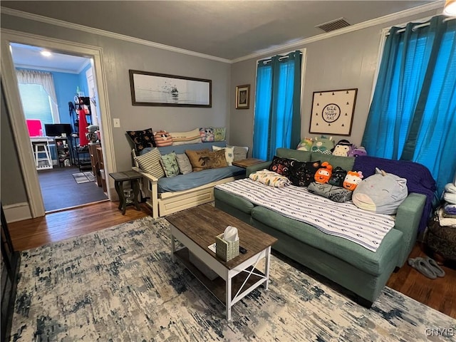 living room featuring wood-type flooring and crown molding