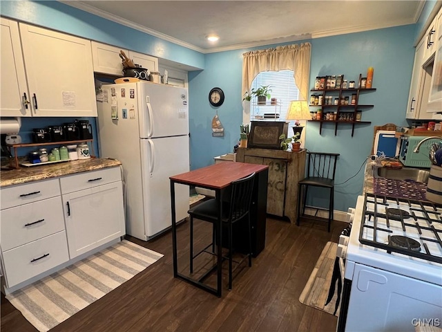 kitchen featuring crown molding, white appliances, light stone countertops, dark wood-type flooring, and white cabinets