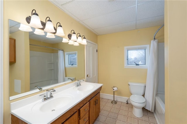 full bathroom featuring toilet, shower / tub combo, a paneled ceiling, and vanity