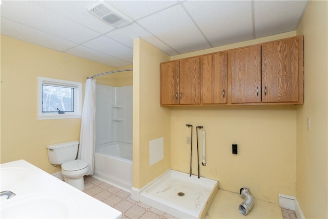 full bathroom featuring toilet, shower / tub combo, a paneled ceiling, and vanity