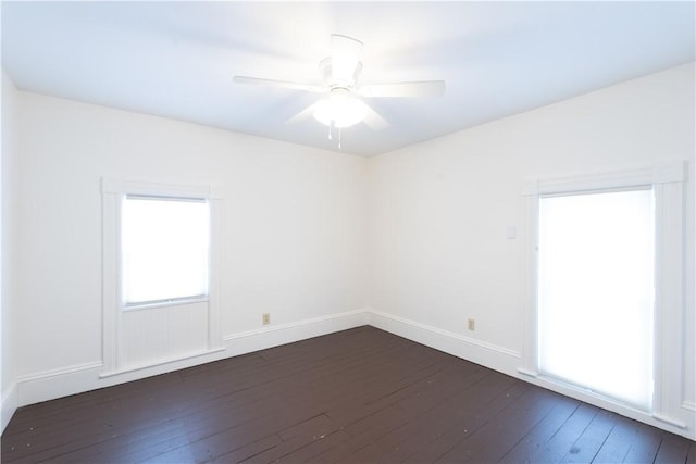 spare room featuring ceiling fan and dark hardwood / wood-style flooring