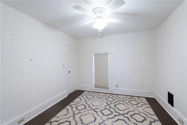 spare room with ceiling fan and dark hardwood / wood-style floors