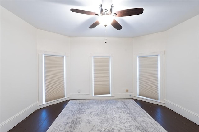 unfurnished room with ceiling fan and dark hardwood / wood-style floors