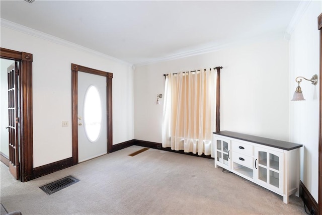 entryway with light colored carpet and ornamental molding