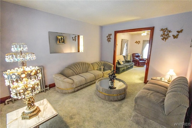 carpeted living room with ceiling fan