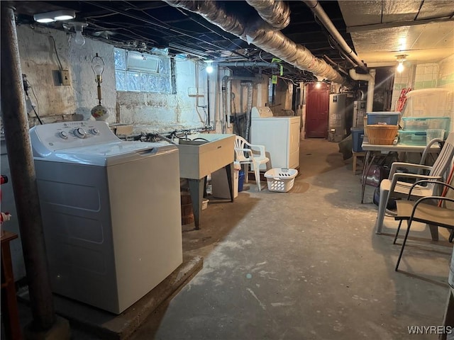 basement featuring washing machine and dryer and gas water heater