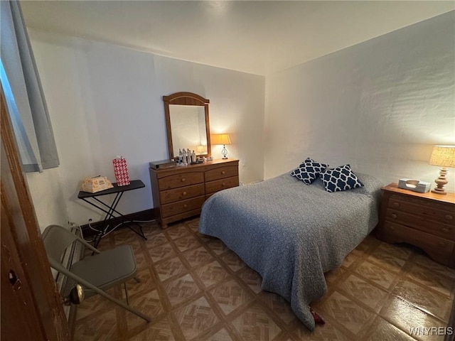 bedroom featuring parquet flooring