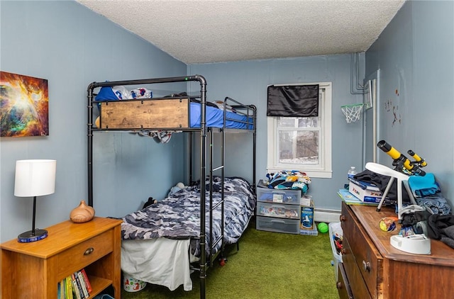 bedroom featuring carpet floors, baseboard heating, and a textured ceiling