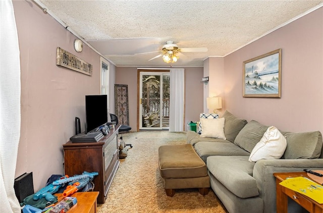 living room featuring ceiling fan, a textured ceiling, and crown molding