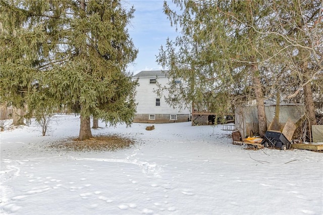 yard layered in snow featuring a wooden deck