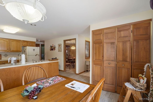 dining room with sink and light hardwood / wood-style flooring