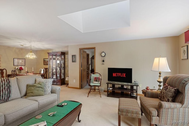 carpeted living room featuring an inviting chandelier