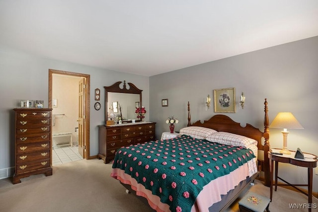 carpeted bedroom featuring ensuite bath