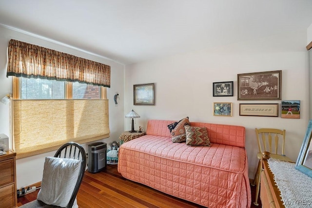 bedroom with dark hardwood / wood-style flooring