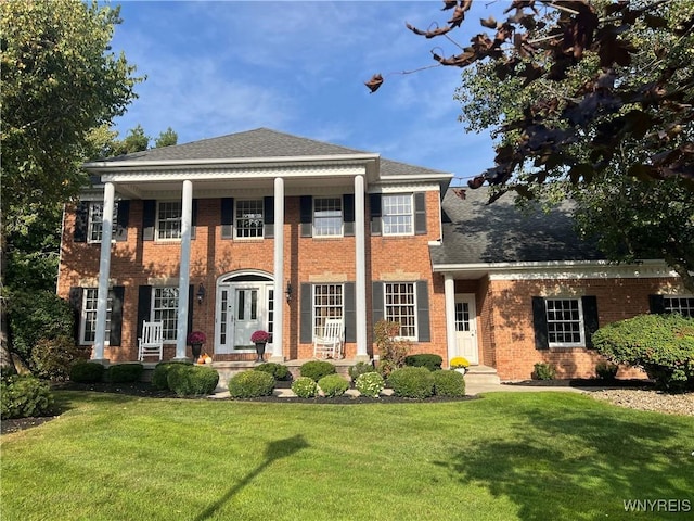 greek revival inspired property featuring a front yard