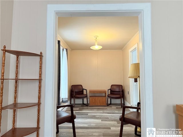 sitting room featuring crown molding and wood finished floors