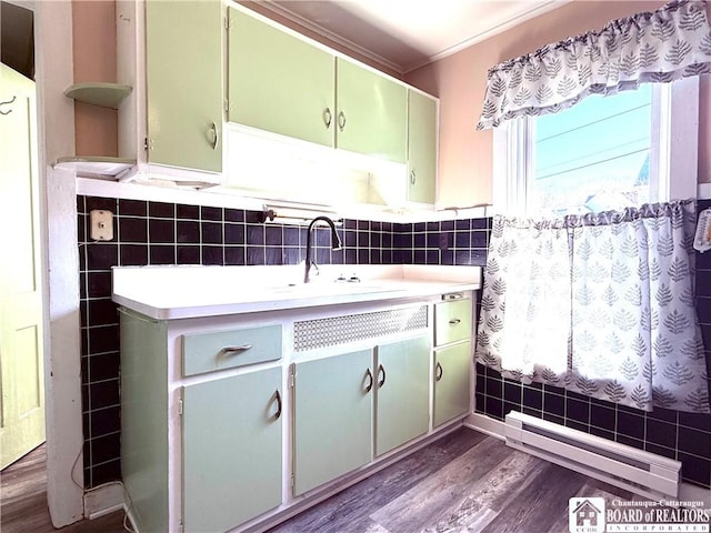 bathroom featuring ornamental molding, wood finished floors, tile walls, a baseboard radiator, and vanity