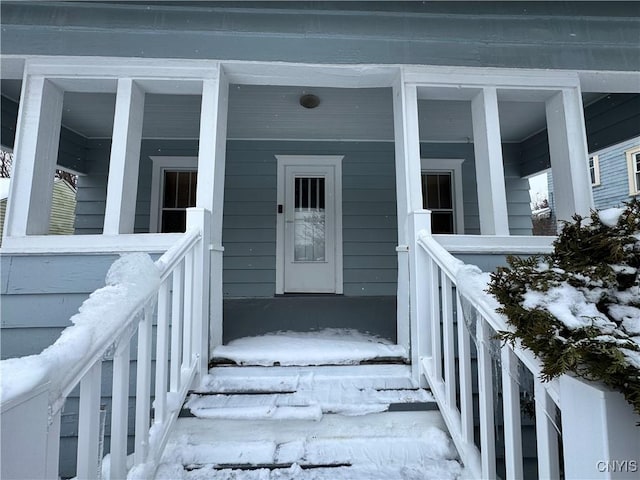 view of snow covered property entrance