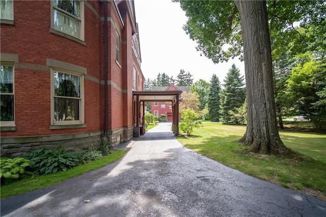 view of side of home with a yard