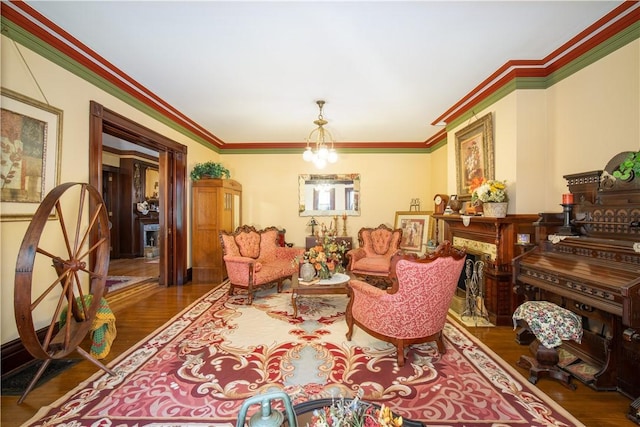 living room with dark hardwood / wood-style flooring, crown molding, and a notable chandelier