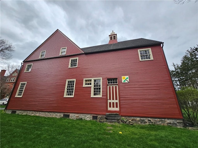 rear view of property with a yard