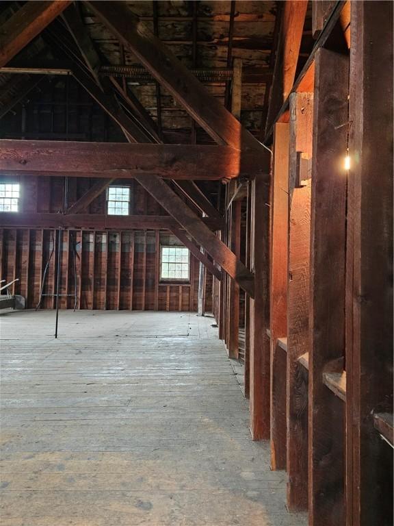 unfinished attic featuring a healthy amount of sunlight