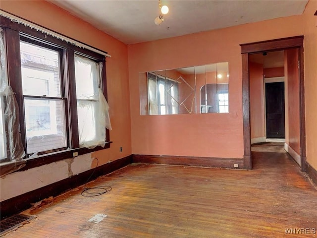 spare room with hardwood / wood-style flooring