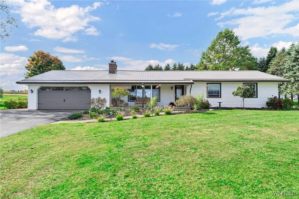 ranch-style house featuring a front lawn, a garage, and a porch