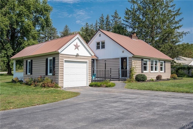 view of front of home with a front yard and a garage