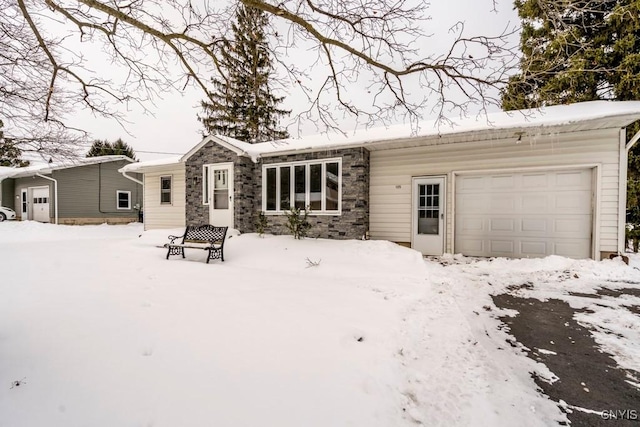 snow covered property with a garage