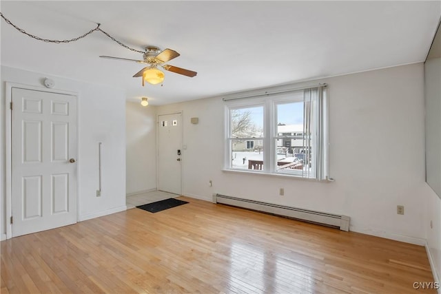 entrance foyer featuring light wood-type flooring, ceiling fan, and a baseboard radiator