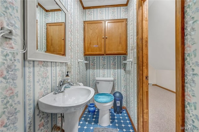 bathroom with toilet and ornamental molding