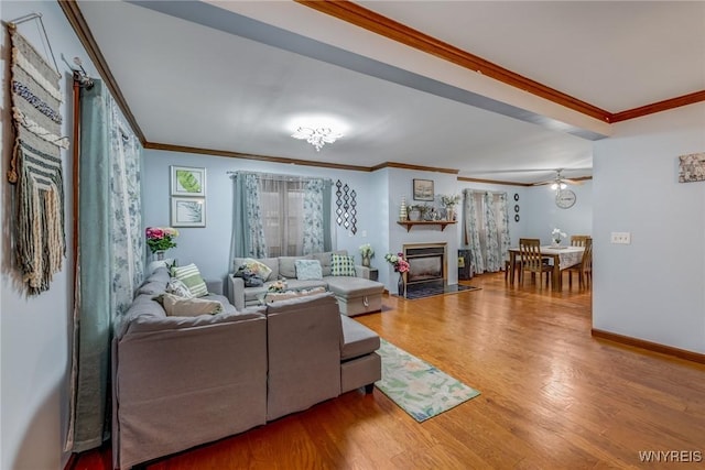 living room featuring ceiling fan, crown molding, and hardwood / wood-style flooring