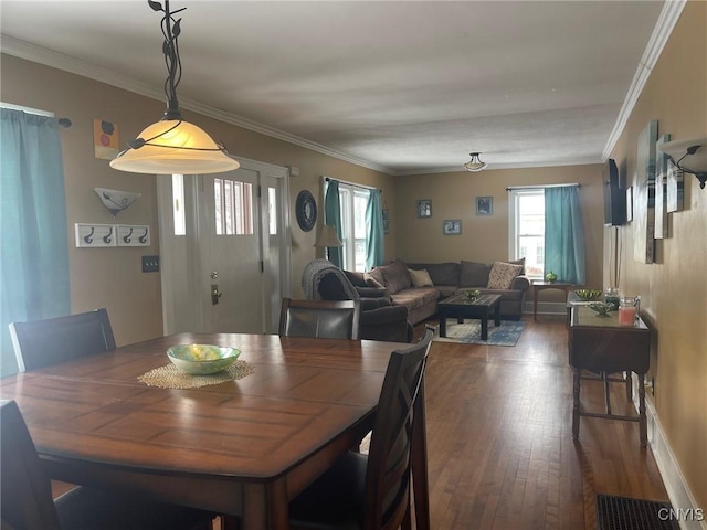 dining area with dark hardwood / wood-style flooring and ornamental molding