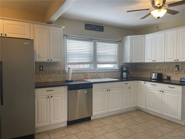 kitchen featuring sink, white cabinets, appliances with stainless steel finishes, and tasteful backsplash