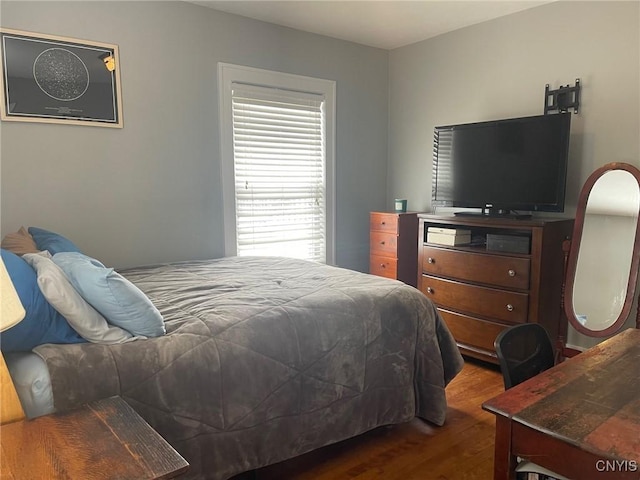 bedroom with dark hardwood / wood-style floors