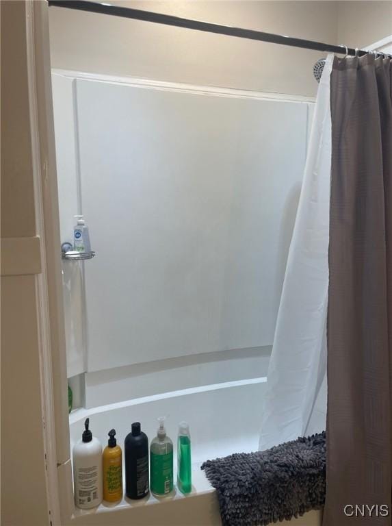 bathroom with shower / bathtub combination with curtain