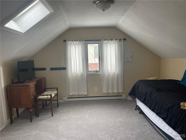 carpeted bedroom with baseboard heating and vaulted ceiling with skylight