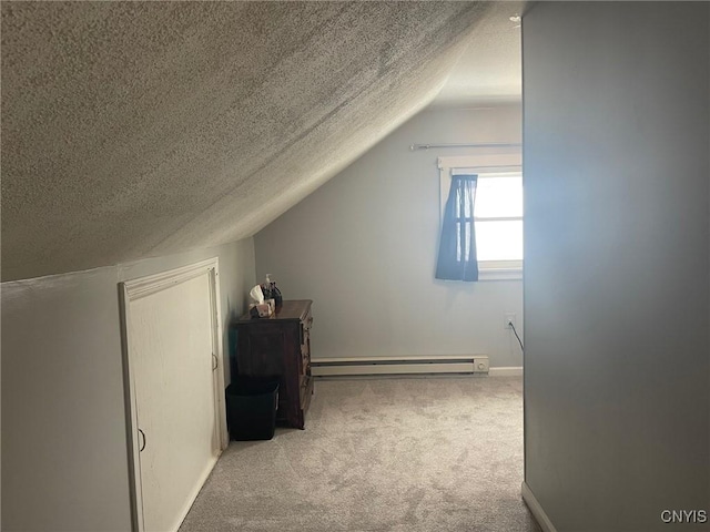 additional living space featuring light carpet, lofted ceiling, a textured ceiling, and a baseboard radiator