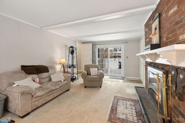 living room featuring beam ceiling, light colored carpet, a fireplace, and ornamental molding