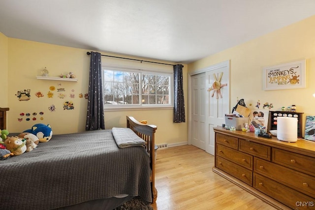 bedroom with a closet and light hardwood / wood-style flooring