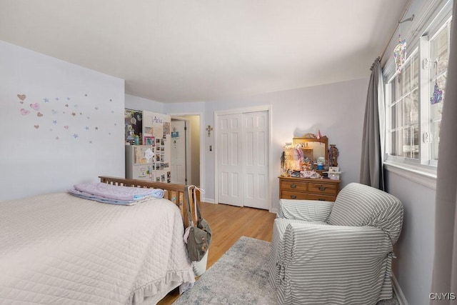 bedroom with light hardwood / wood-style flooring and a closet