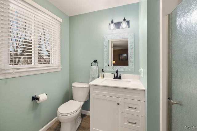 bathroom featuring toilet and vanity