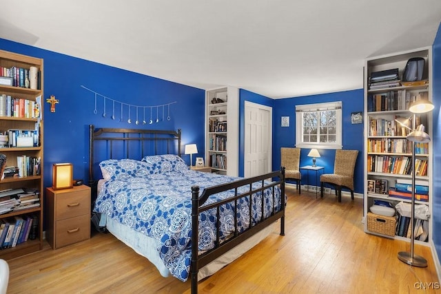 bedroom with wood-type flooring and a closet