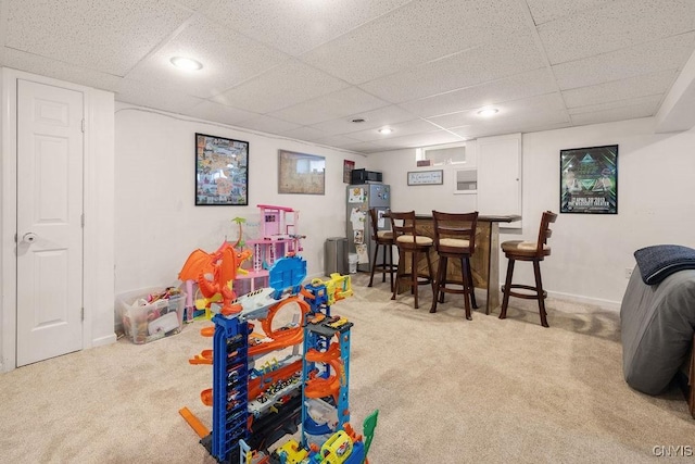 game room featuring carpet, a drop ceiling, and bar