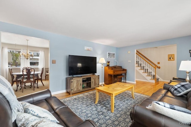 living room featuring an inviting chandelier and wood-type flooring