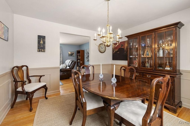 dining space featuring a chandelier and light hardwood / wood-style flooring