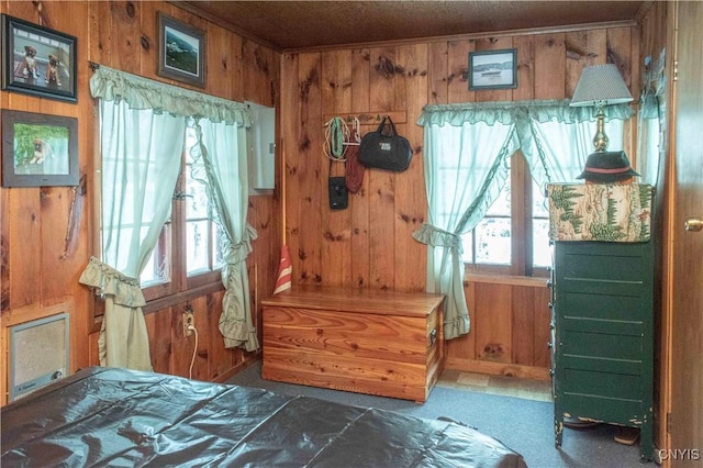 bedroom featuring wooden walls