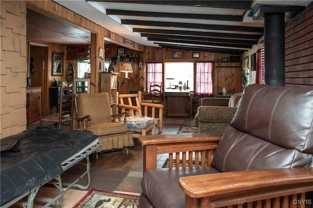 living room with hardwood / wood-style floors, vaulted ceiling with beams, and wooden walls